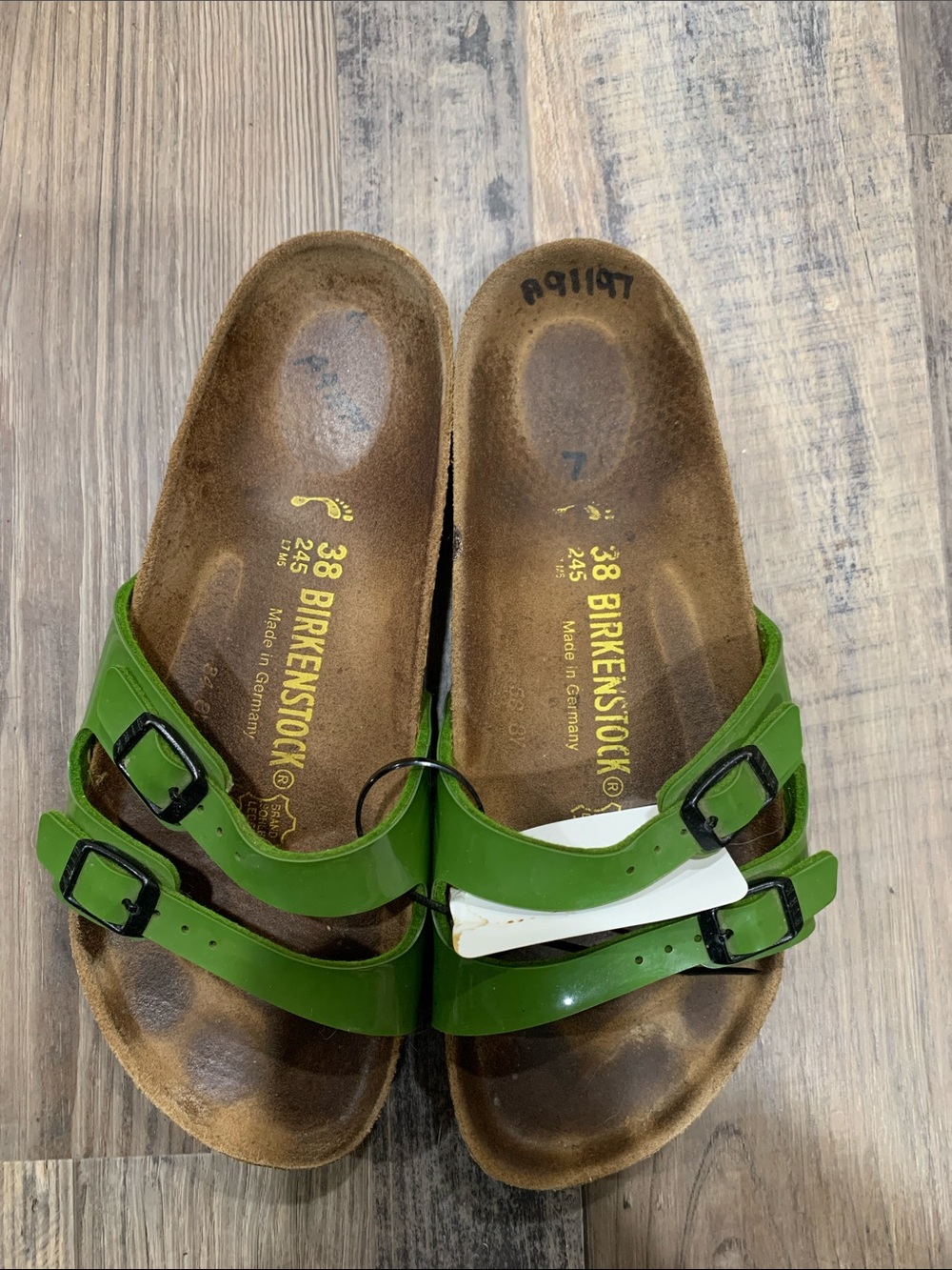 Birkenstock Arizona Two-Strap Sandals in Glossy Green with Black Buckles